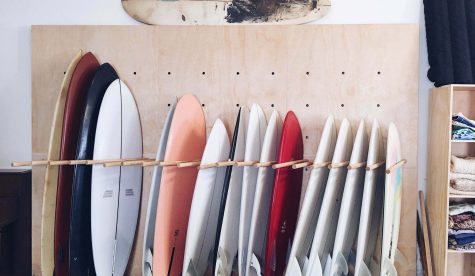 Surfboards lined up for rent in surf cafe shop